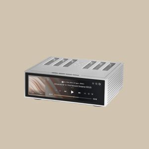 RS520 lyser i silver och streamar låtar med en livfull display med låtinformation och albumomslag, mot en enkel beige bakgrund.