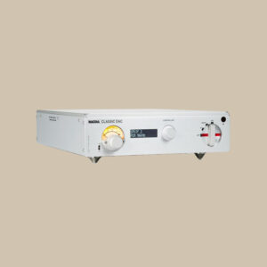 Den eleganta silverfärgade Nagra Classic DAC II, med glödande digital display och taktila reglage, väntar på musikmagi på en beige bakgrund.